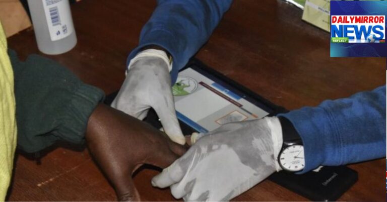 An IEBC official records a voter's biometric details during voter registration.
