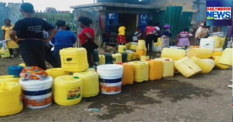 An image showing people lining up with jerricans to fetch water.